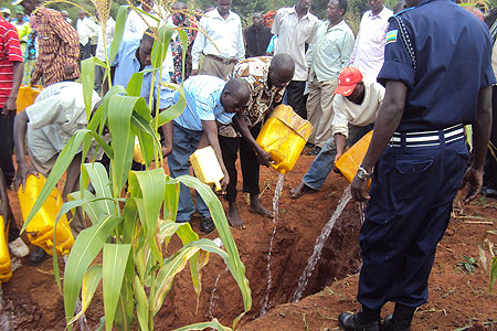 Residents, Police dumping local potent gin  (Kanyanga) in Gatsibo District ( Photo / D. Ngabonziza)