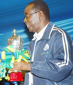 Prime Minister Bernard Makuza with the runners-up trophy  of the 2008 Zone 5 basketball championship. He has backed Rwandau2019s bid to host the African Cup of Nations. (File photo)