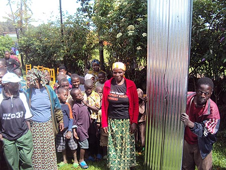 Some of the beneficiaries receiving the iron sheets in Shingiro sector (Photo B. Mukombozi)