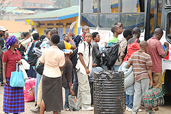 BACK TO SCHOOL; Students queue up to board a bus to school. Transport  becomes a problem on first days of school (Photo T. Kisambira)