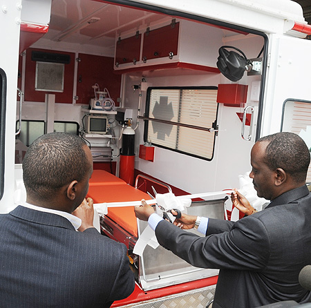 A fleet of the new ambulances handed out yesterday. (Inset) Health Minister Dr. Richard Sezibera (C) commissioning the new ambulances. (Photo J Mbanda)  