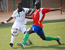 Ivory Coast's Ange Lionel Lago (left) battles for possession with Gambia's Abdoulie Bass during yesterday group B game at Kigali Regional Stadium. (Photo; E. Niyonshuti)