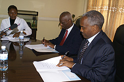 Ministers Charles Murigande (right) and  Evans Lescouflair signing the MoU yesterday (Courtesy photo)