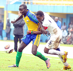 Junior wasps midfielder Eric Nsabimana hands off a Burkina Faso player.  The West Africans lost the tie 1-2.(Photo / T. Kisambira)