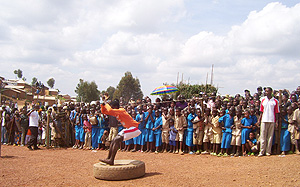 Children watch acrobats during celebrations to mark World Refugee Day at Gihembe Refugee camp in 2007. (File photo)