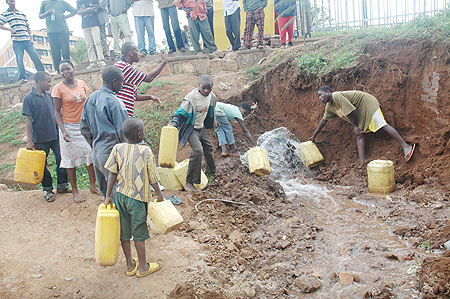 Kigali residents taking advantage of a broken pipe to get water. Shortage has been blamed on heavy rains