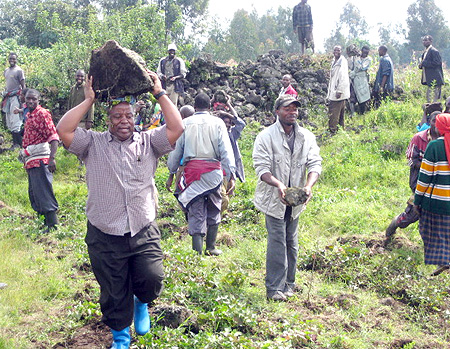 Govenor Aime Bosenibamwe taking part in the construction of houses in Shingiro.(Photo B Mukomboz)