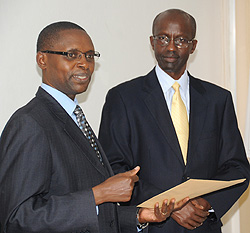 State Minister, Dr Mathias Harebamungu (L),recieves the results from RNEC boss John Rutayisire, yesterday (Photo T Kisambira)