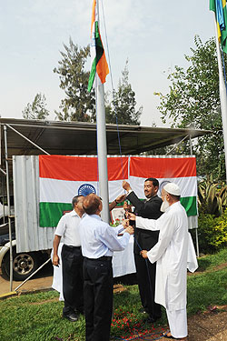 Indians hoisting their flag during the celebration of the India Republic Day yesterday (photo T Kisambira)