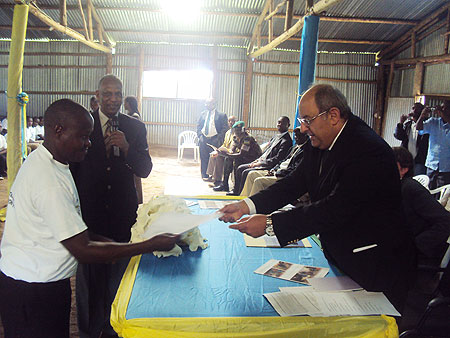 Egyptian Ambassador Khaled Abdel Rahman give a certificate to Elie Mutarambirwa (Col) as Jean Sayinzoga looks on. (Photo B Mukombozi)