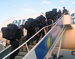 Police officers board a plane to Haiti (Photo by Ivan R. Mugisha)