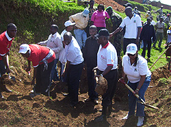 Minister Gatsinzi (2nd R) flanked by Mayor Bonane Nyangezi participate in Umuganda to dig water collection trenches (Photo A.Gahene)