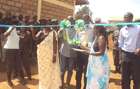 Defence Minister, Gen. James Kabarebe accompanied by Kicukiro Mayor, Paul Jules Ndamage, and other officials cuts the ribbon ( Photo. G. Mugoya)