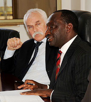 Hon Gideon Kayinamura, Chairperson of the Foreign affairs committee (R), stresses a point while Hugo Fasel , the head of the Swiss delegation listens (Photo T Kisambira)