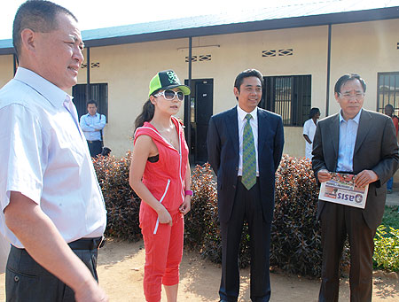 The chairman of World Eminence Chinese Business Association Junqing Lu(Second right) during a tour of Kagugu school (courtesy photo)