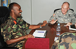 Chief of Defence Staff Lt Gen Charles Kayonga shares a light moment with Maj Gen David Hogg (Photo: J. Mbanda)