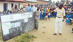 Provincial Executive Secretary Paul Jabo showing the residents the proposed village Master Plan (Photo S Nkurunziza)