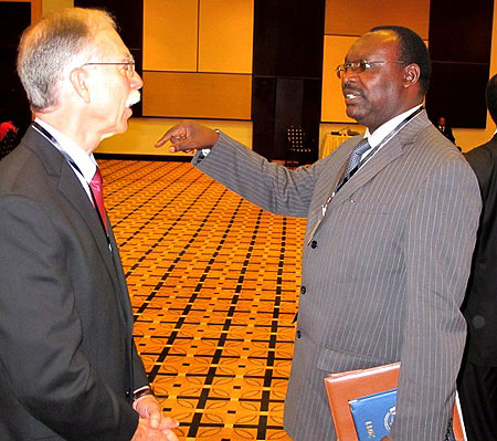 Central Bank Governor Francois Kanimba speaking to Richard Newfarmer of IGC at the forum yesterday (Photo T.Kisambira)