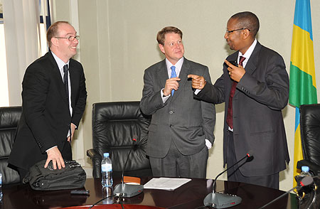 Finance Minister John Rwangombwa (R) with the CEO Trade mark EA (C) Frank Matsaert  and UK High Commissioner, Benedict Llewellyn,  at the signing ceremony. (Photo J Mbanda)