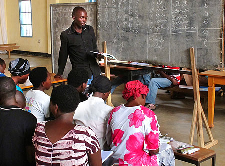 Adults taking part in a literacy class  in Kicukiro District, yesterday. (Photo T Kisambira)