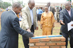  Local Government Minister James Musoni (2nd L)laying the foundation stone  for the school assisted by Kigali City Executive Secretary, Jean Marie Matabaro.   (Photo T.Kisambira)