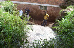 The owner of the house next to the abbatoir  and attempt to stop the sewage flow. (Photo by A.Gahene)