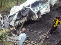 Residents at the wreckage of the taxi which was involved in the  fatal accident.Photo: B. Mukombozi.JPG