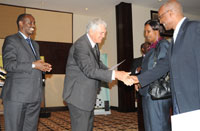 Prof.Stuart Whittaker(C)  shakes hands with KFH staff as Health Minister Dr Richard Sezibera looks on. (Photo T Kisambira)