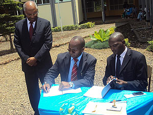 INES Rector Fr Dr Deogratias Niyibizi sign the MOU, with Sopyrwa Director Gabriel Bizimungu as ISAE Rector Dr Charles Karemanjingo