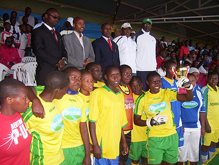 APAPEB High school girls welcome a trophy awarded to them after defeating teachers in a football match on Sunday. (Photo:  A. Gahene)