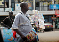 A hawker selling movie CDs on a Kigali street