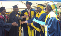 Prof Rwigamba Balinda (c) congratulating Gaspard Nzabonimpa, the best overall student ,during the ceremony yesterday (Photo A Ngarambe)