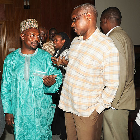 EALA MP AbdulKarim Harelimana (L) talks to RDBu2019s Emmanuel Werabe after a meeting between hoteliers and members of the East African Legislative Assembly on Friday (Photo J Mbanda)