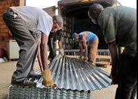 Iron sheets being loaded on the truck to be delivered to desginated districts yesterday (Photo T.Kisambira)