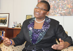 Ms. Ezekwesili speaking to journalists in Washington office, the picture of African market teeming with female traders in the backdrop. (Photo Herbert Boh, World Bank.)