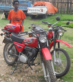 Claudine Umunyaneza with the recovered motorcycles at Bwishyura post station in Karongi district (Photo S Nkurunziza)