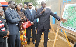 Minister Stanislas Kamanzi (L) and State Minister Colletha Ruhamya, being shown a water supply Network in Kicukiro District yesterday.(Photo J Mbanda)