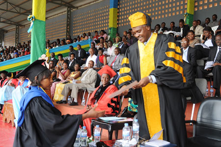 Education Minister Dr. Charles Murigande awards Grace Irakiza, the best female student in the 2010 academic year. (Photo T Kisambira)