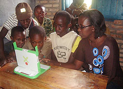 Caritas Kanizio, a Mineduc official gives ICT lessons to some of the Ruli Primary School pupils after the handover.Photo D.Sabiti)