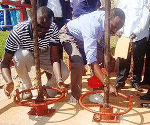 Minister Kamanzi (L) and Governor of Southern Province Alsphonse Munyentwali open the water dyke. (Photo G.H. Mwizerwa)