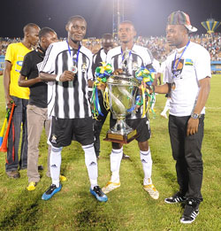 Former APR Captain Patrick Mafisango (L) and Kalisa Mao showing off last yearu2019s Kagame Cup trophy moments after being crowned champions. APR beat St. George in the final. (File photo)