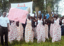 Rural women display brooms as a tradtional tool of maintaining cleanliness in homes. Photo S. Rwembeho (2).