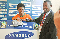 Nicholas Musonye (R) handing over the u2018man of the matchu2019 award to an Ivory Coast player during the 2009 Caf U-20 championship. (File photo)