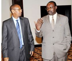 Central Bank Governor, Francois Kanimba (R)chats with the Finance Minister John Rwangombwa during the Monetary Policy statement presentation recently (File photo)