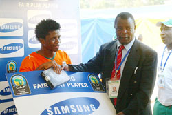 Cecafa SG Musonye (R) handing over the man of the match award to an Ivory Coast player during the 2009 U-20 Africa Championship. (File photo)