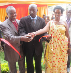 L-R; Bishop Sendegeya, Kicukiro District Mayor, Jules Ndamage and BIRD Legal Representative Merry Munyangaju cutting the ribbon to officially launch the project (Photo Peter Kamasa).