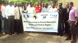 MP Theobald Mporanyi (3rd L) joins journalists for a group photo after the workshop. Photo G. Mugoya.