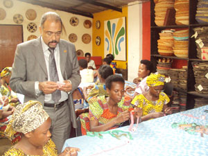 The Executive Director of UNAIDS, Michel Sidibe admires one of the women`s products at Gahaya Links (Photo. G. Mugoya)