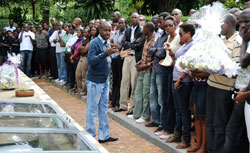 Hope for the Future youths being briefed before placing a wreath of flowers on the grave of the genocide victims yesterday (Photo T.Kisambira).