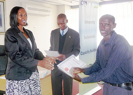 State Minister for Energy, Eng.Coletha Ruhamya handing over a certificate to one of the people who completed training in hydro power at Kafue Gorge Regional Training Centre, Zambia.(Photo / D. Nyesiga)